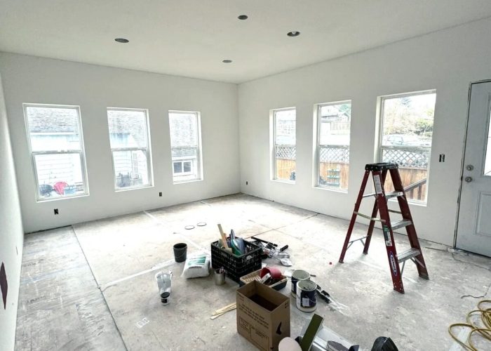 Updated living room with new ceiling and lighting.