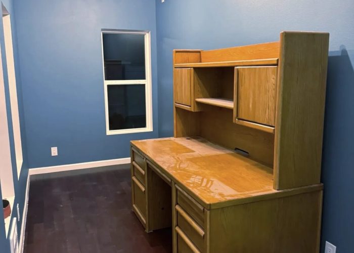 Finished office with blue walls and desk.