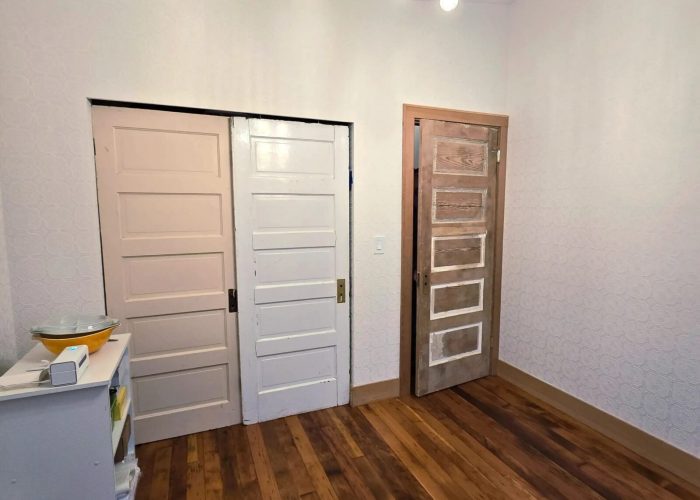 Finished addition bedroom #4 with reclaimed doors.