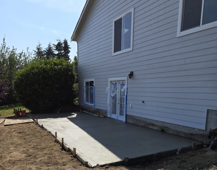 Side view of house with glass double doors to enter the new basement addition.