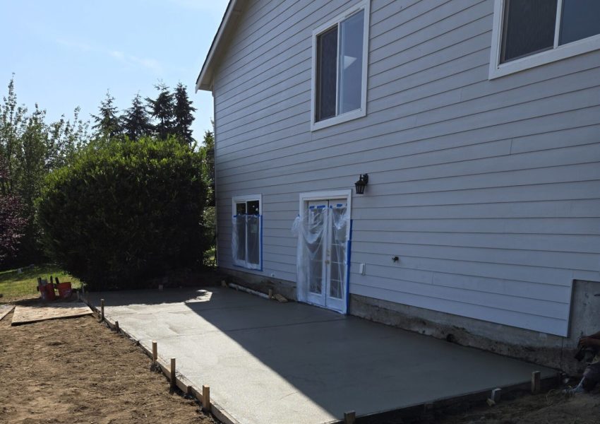 Side view of house with glass double doors to enter the new basement addition.
