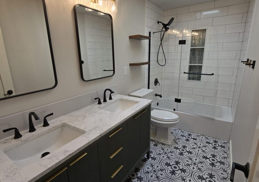 Bathroom remodel with black and white floor tile.