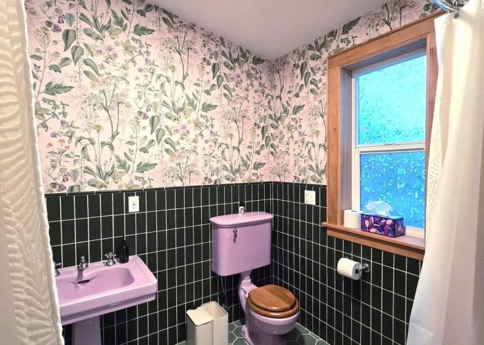 Finished addition's new bathroom with green tiled floor, wall.