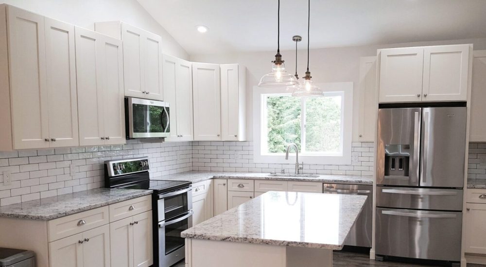 Kitchen remodel in Snohomish with white cabinets and grey countertops.